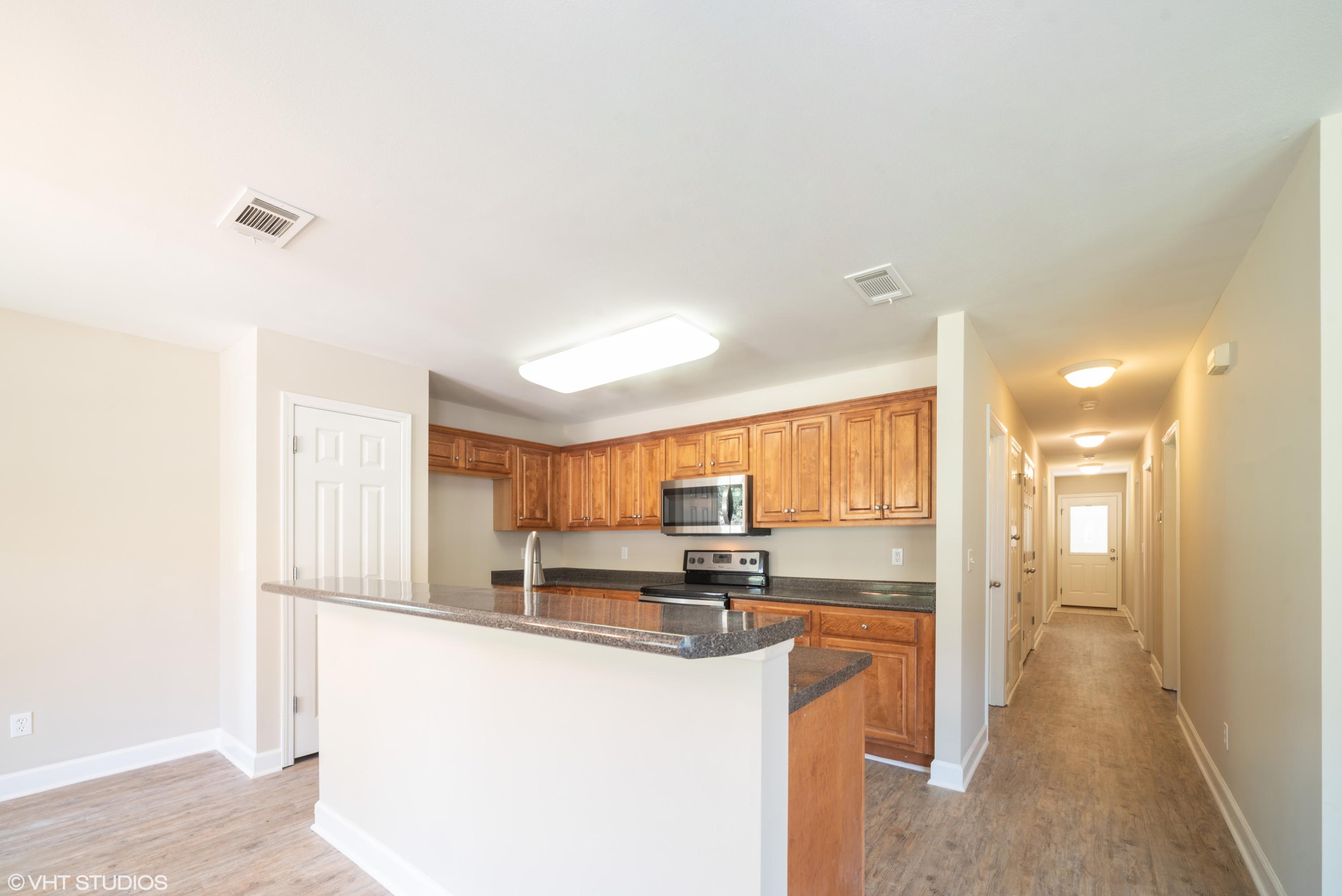 92 Central 7th Street Santa Rosa Beach, FL 32459 - Photo 13 of 25 a kitchen with stainless steel appliances granite countertop a refrigerator and a stove top oven