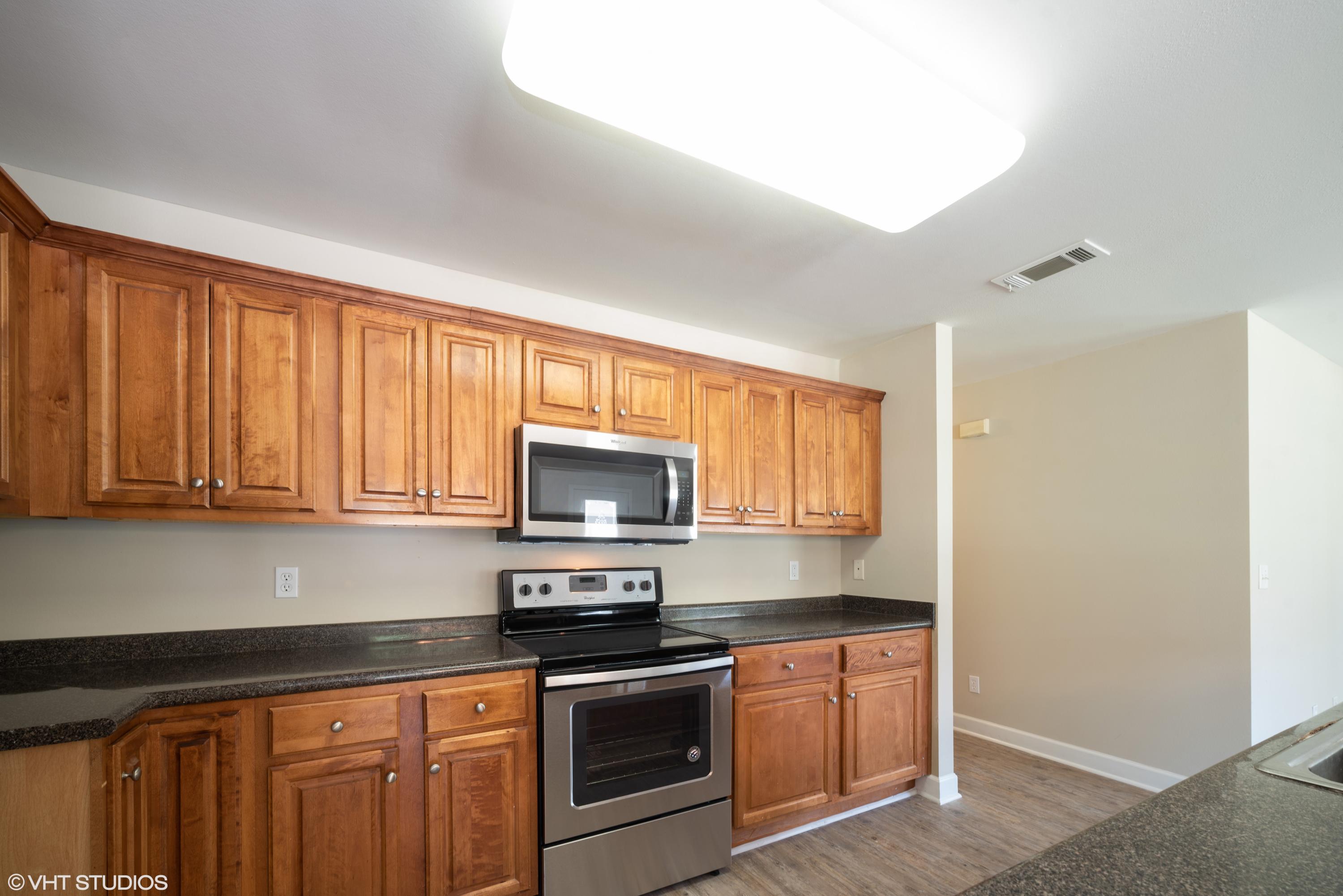 92 Central 7th Street Santa Rosa Beach, FL 32459 - Photo 14 of 25 a kitchen with stainless steel appliances granite countertop a stove a sink and a microwave