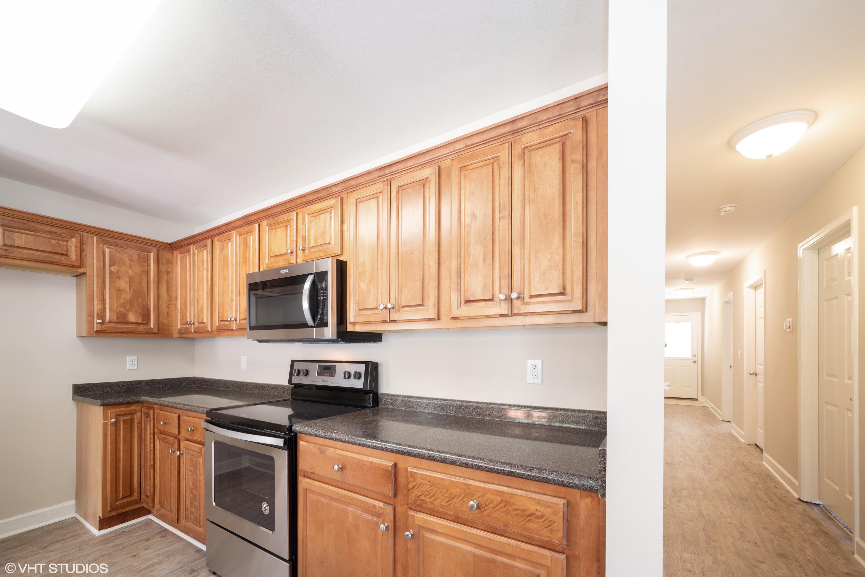 92 Central 7th Street Santa Rosa Beach, FL 32459 - Photo 15 of 25 a kitchen with stainless steel appliances granite countertop a stove a sink and a microwave