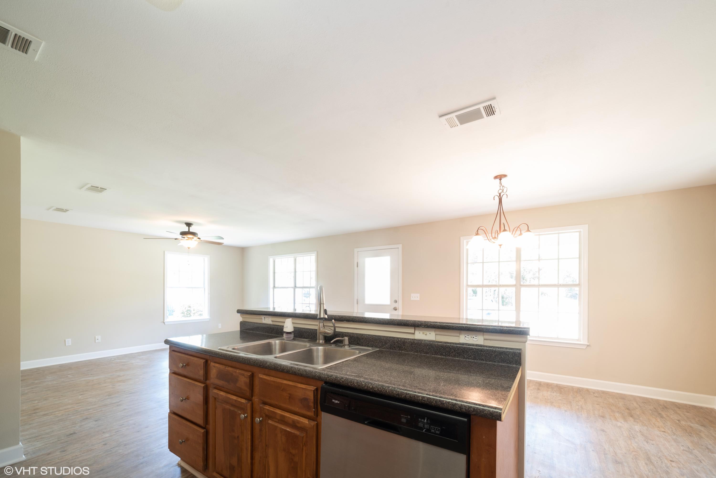 92 Central 7th Street Santa Rosa Beach, FL 32459 - Photo 16 of 25 a kitchen with kitchen island a sink stove and cabinets