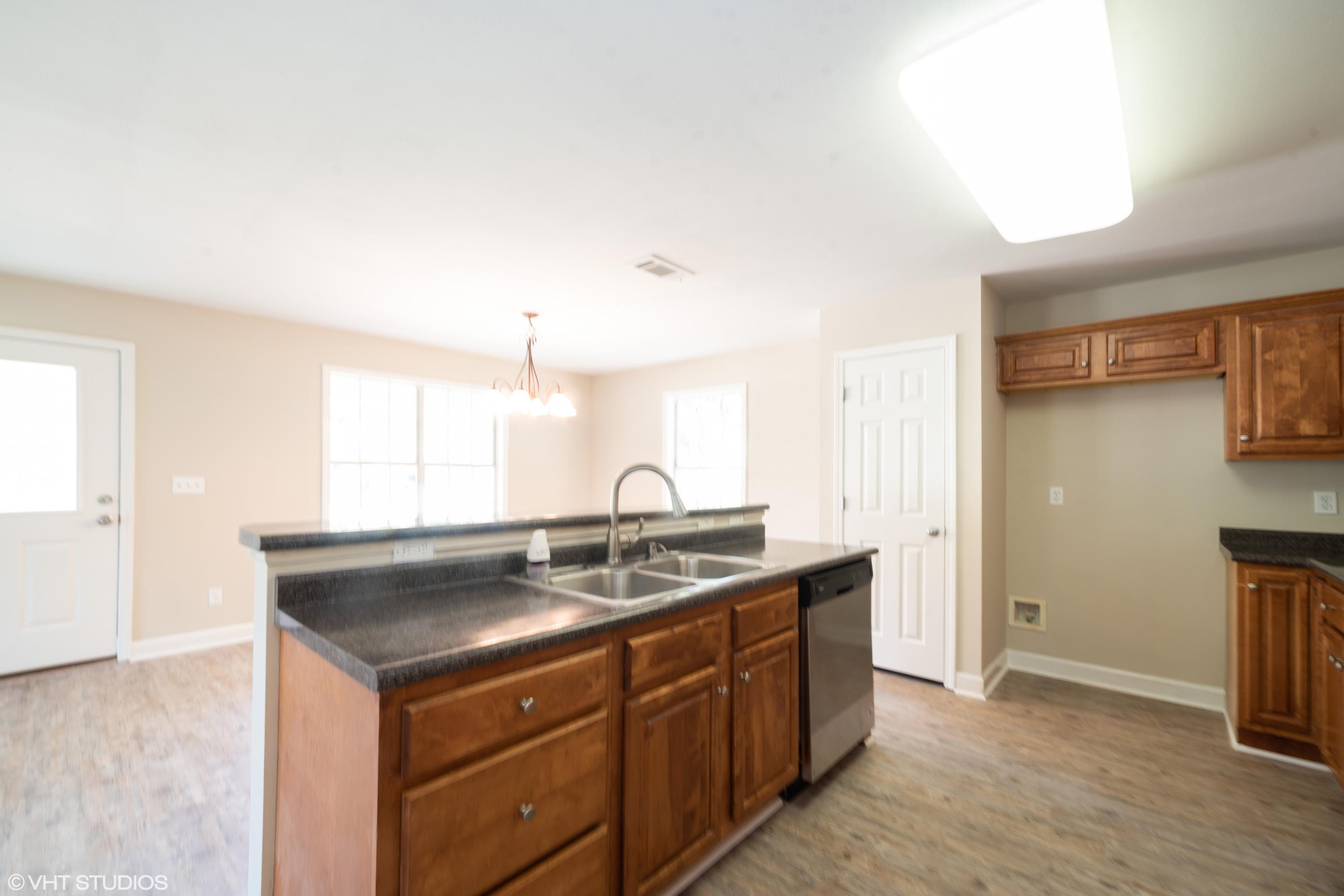 92 Central 7th Street Santa Rosa Beach, FL 32459 - Photo 17 of 25 a kitchen with a sink stove and cabinets