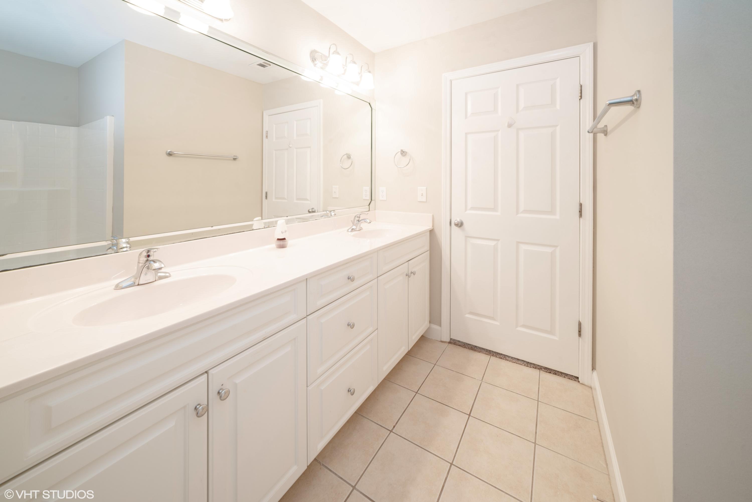 92 Central 7th Street Santa Rosa Beach, FL 32459 - Photo 20 of 25 a spacious bathroom with a double vanity sink a mirror and a