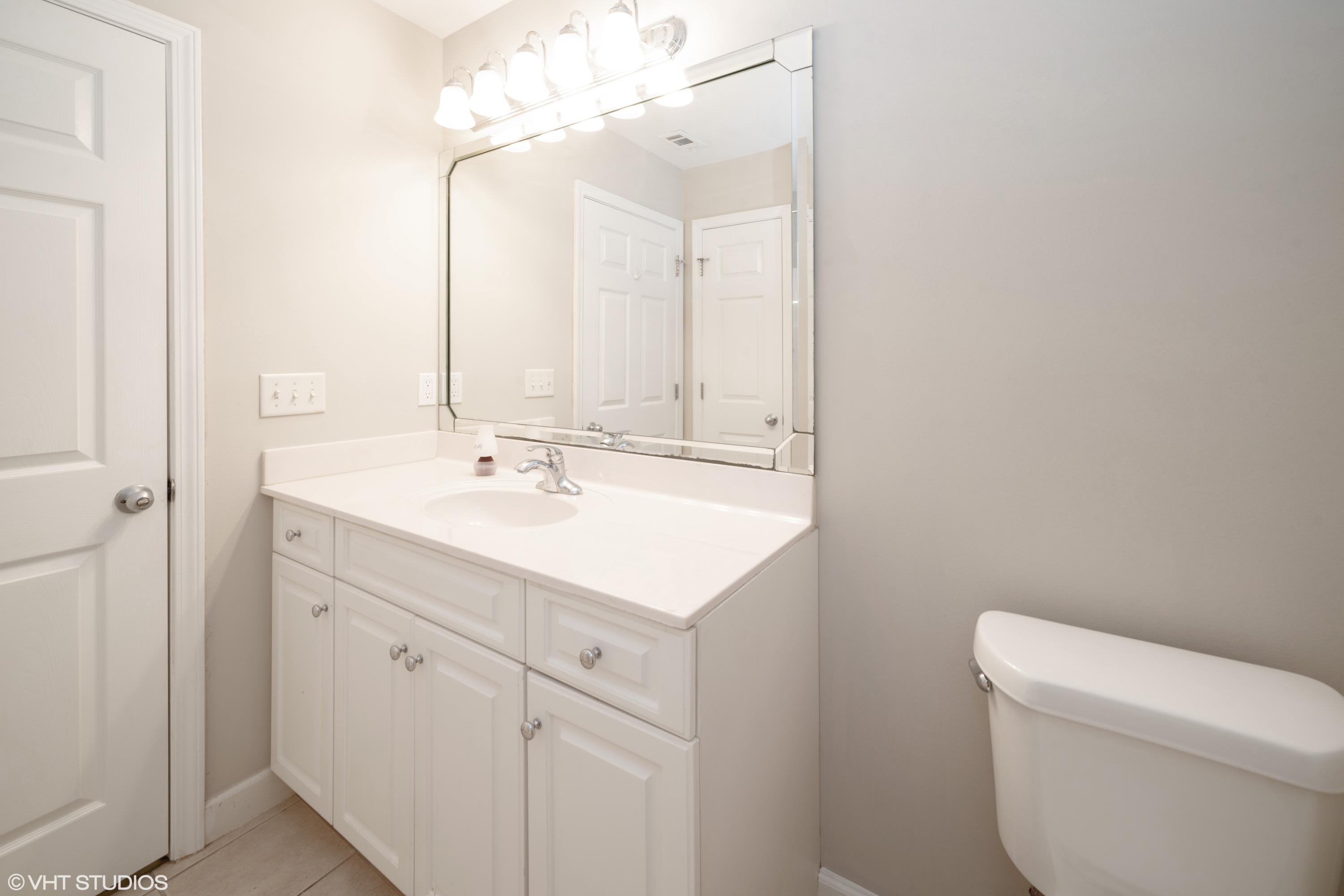 92 Central 7th Street Santa Rosa Beach, FL 32459 - Photo 24 of 25 a bathroom with a sink a toilet and a mirror