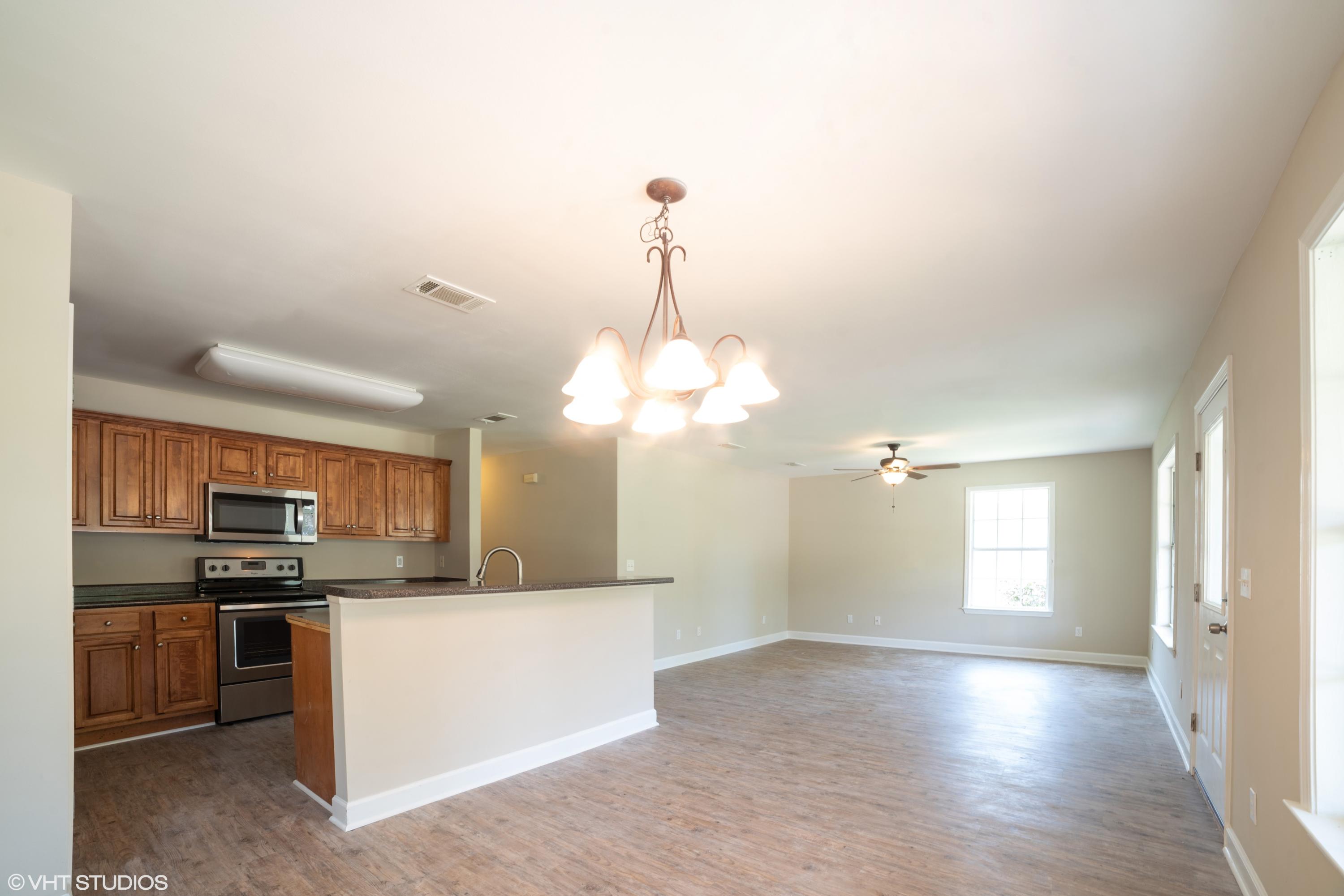 92 Central 7th Street Santa Rosa Beach, FL 32459 - Photo 10 of 25 a view of a kitchen with a sink and dishwasher a oven with wooden floor
