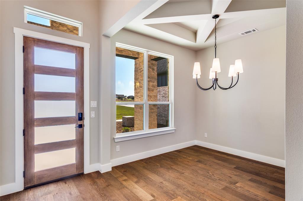 555 Aermotor Loop Weatherford, TX 76085 - Photo 6 of 30 a view of an empty room with wooden floor and window