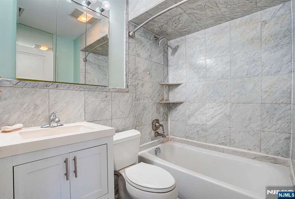 54 Polk Street, Unit P3 Newark, NJ 07105 - Photo 14 of 26 a bathroom with a sink a toilet and shower
