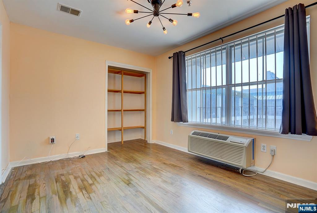 54 Polk Street, Unit P3 Newark, NJ 07105 - Photo 15 of 26 wooden floor in an empty room with a window
