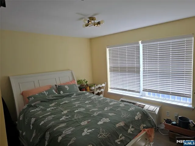 a bed sitting in a bedroom next to a window