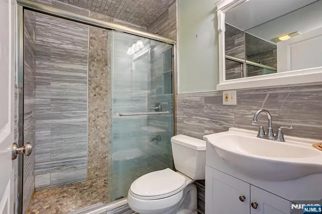 a bathroom with a toilet a sink and shower
