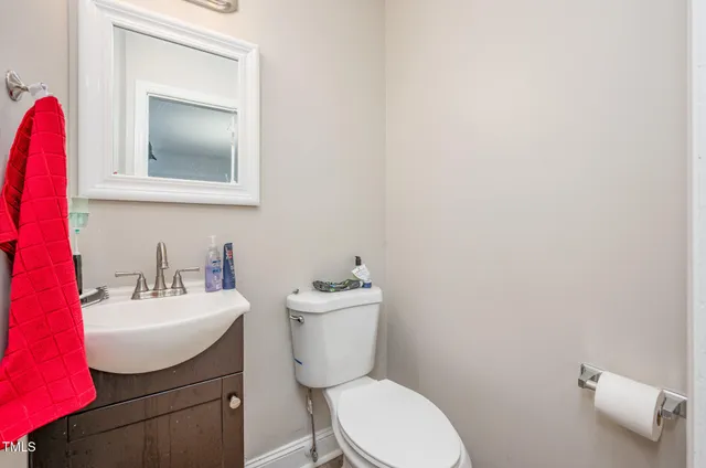 a bathroom with a sink mirror and toilet