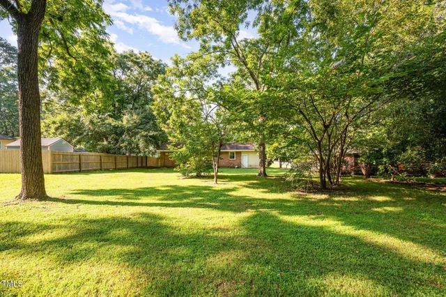a swimming pool with trees in the background