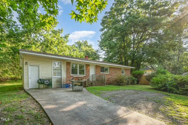 a view of a house with a yard and plants