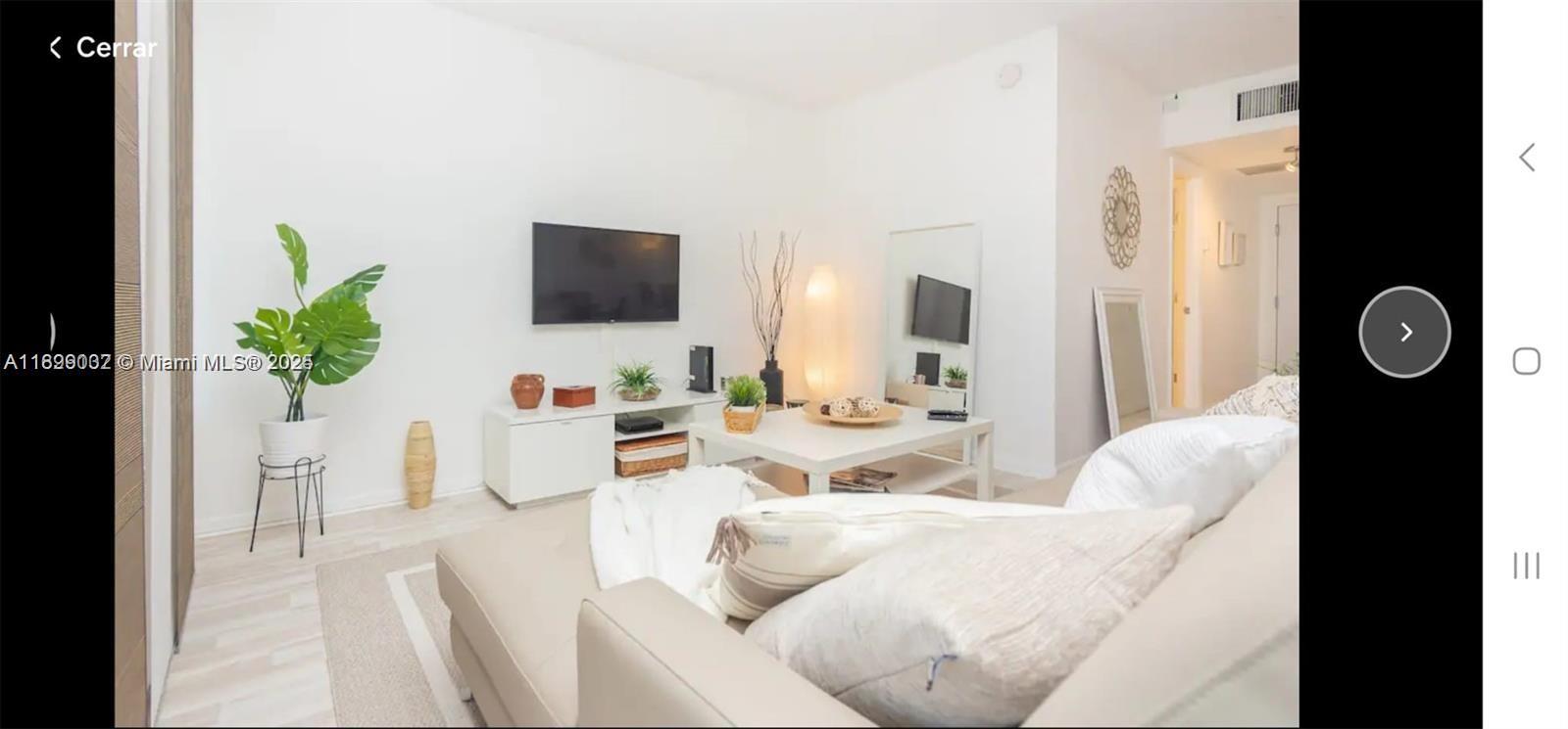 2301 Collins Avenue, Unit 736 Miami Beach, FL 33139 - Photo 4 of 15 a living room with furniture and a flat screen tv