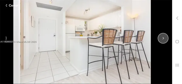 a kitchen with stainless steel appliances granite countertop a refrigerator and a cabinets
