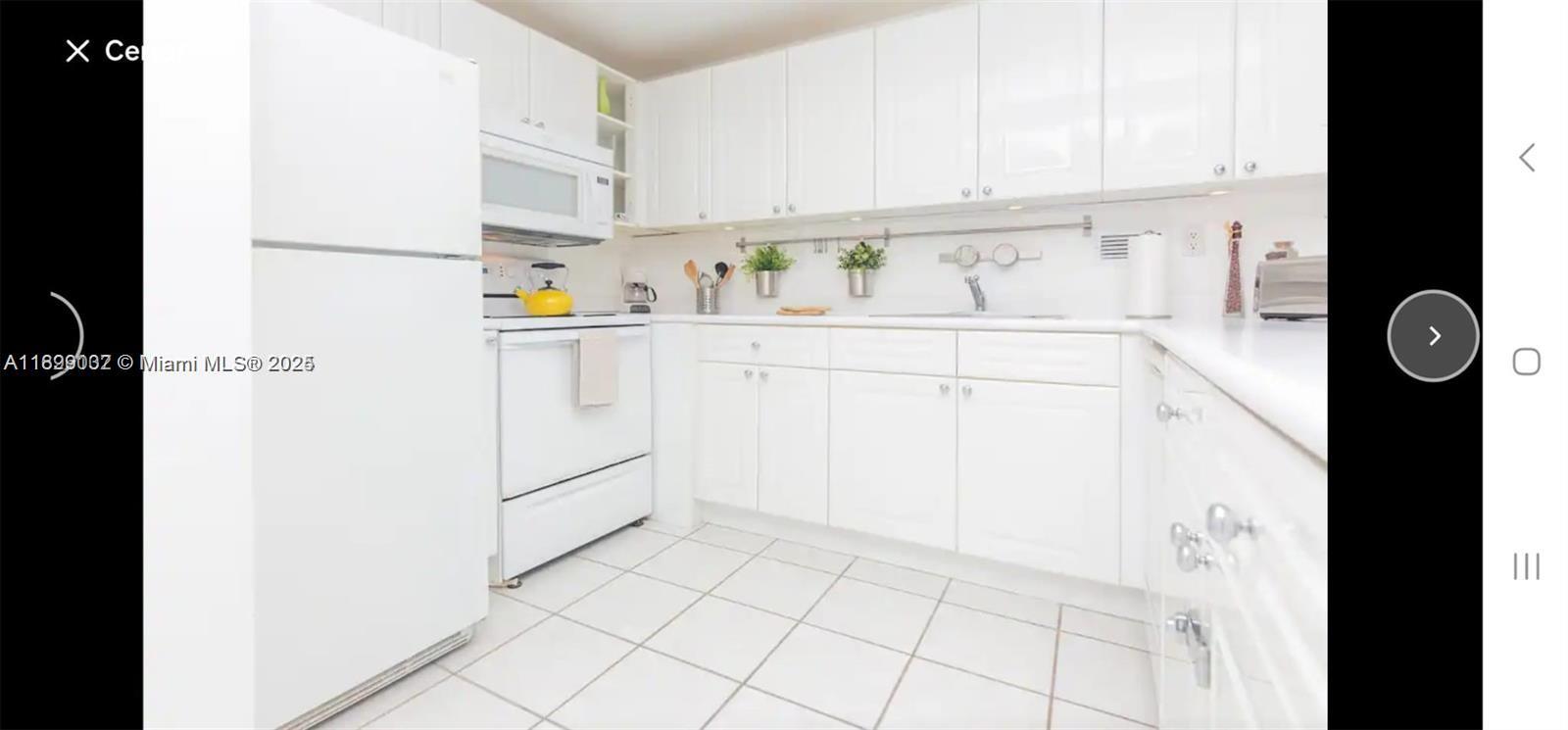 2301 Collins Avenue, Unit 736 Miami Beach, FL 33139 - Photo 8 of 15 a kitchen with cabinets and white appliances