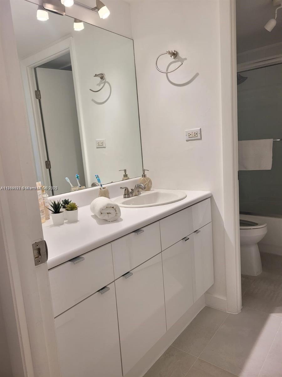 2301 Collins Avenue, Unit 736 Miami Beach, FL 33139 - Photo 9 of 15 a bathroom with a sink and a mirror