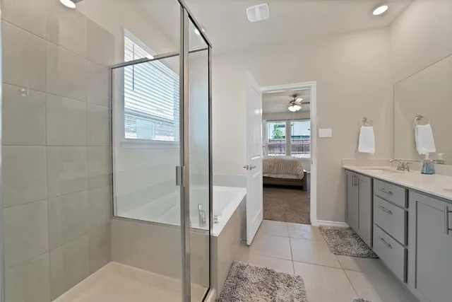 a en suite bathroom with a double vanity sink and a mirror