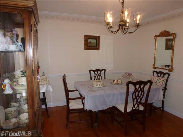 3215 Rolling Road High Point, NC 27265 - Photo 4 of 16 Dining Room. Large Dining Room with Hardwood Floors and chair-railing