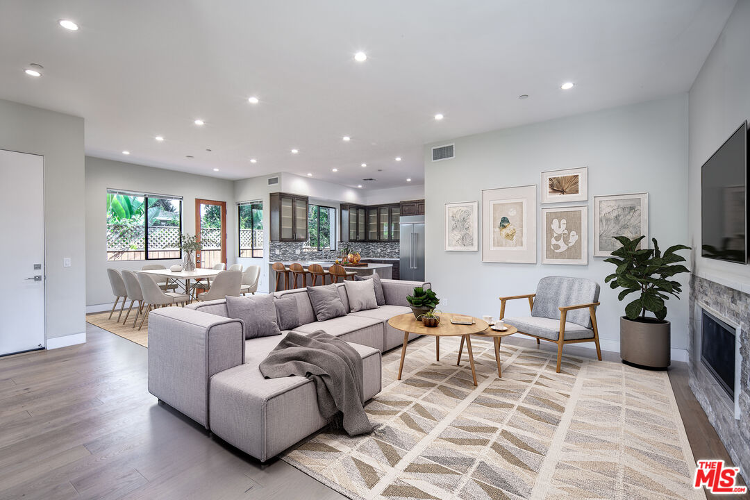 a living room with furniture and a potted plant