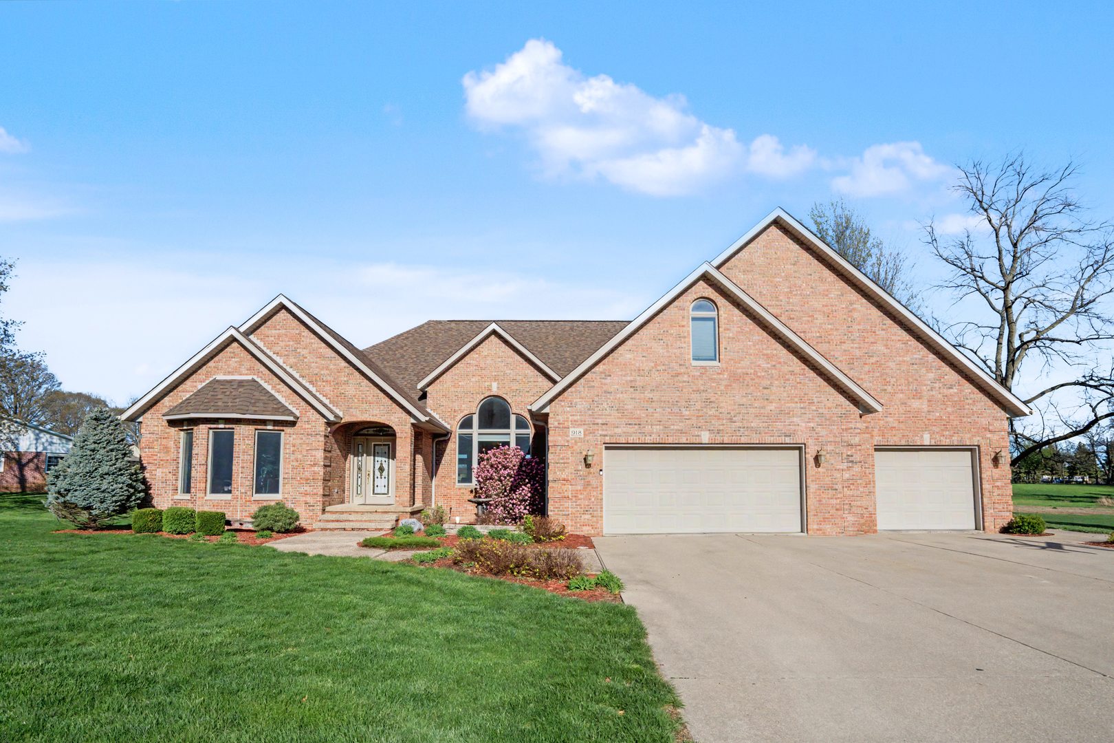 a view of a house with a yard and garage