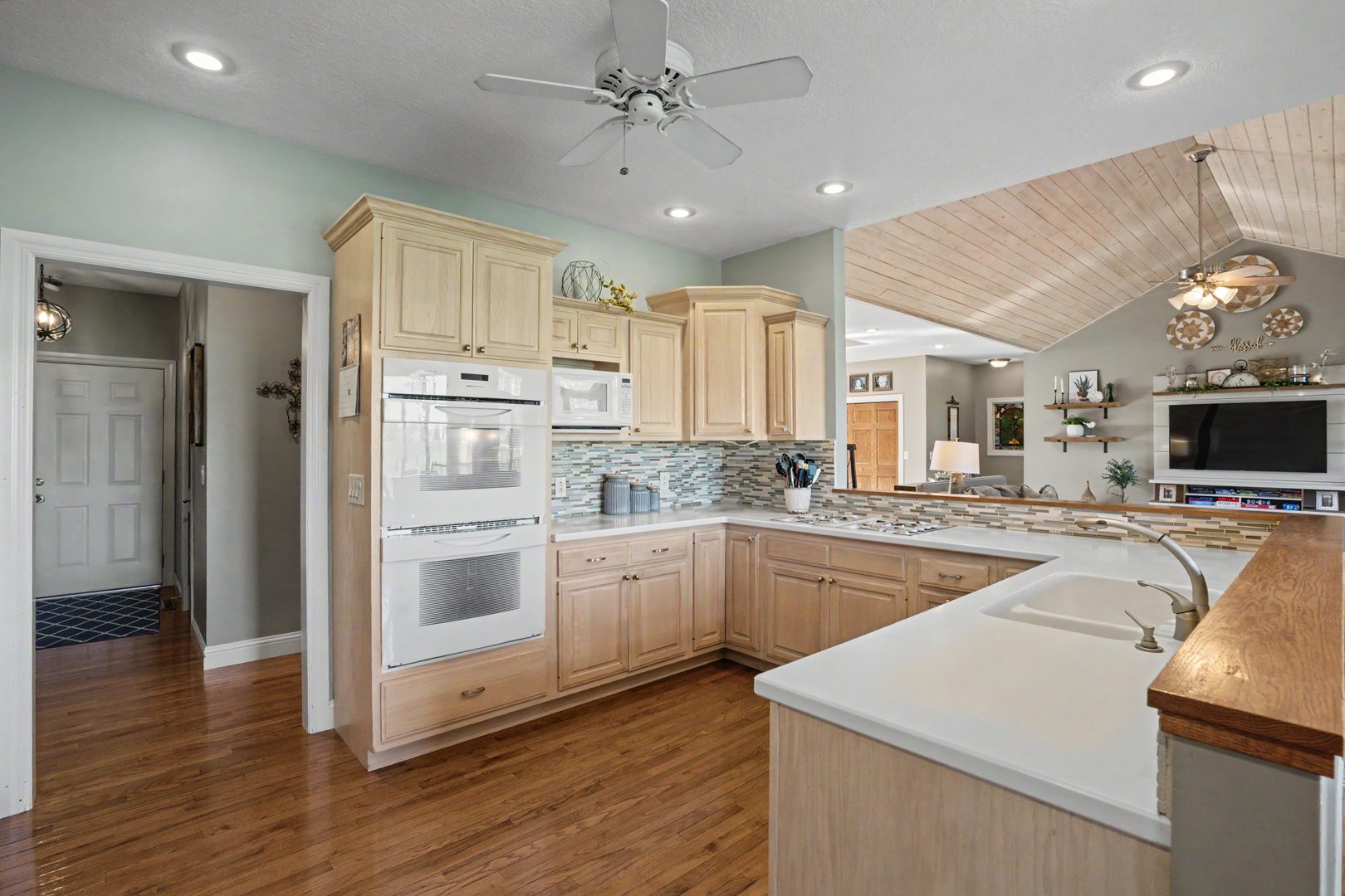 918 Melody Hills Fulton, IL 61252 - Photo 13 of 43 a kitchen with stainless steel appliances granite countertop a sink and cabinets with wooden floor