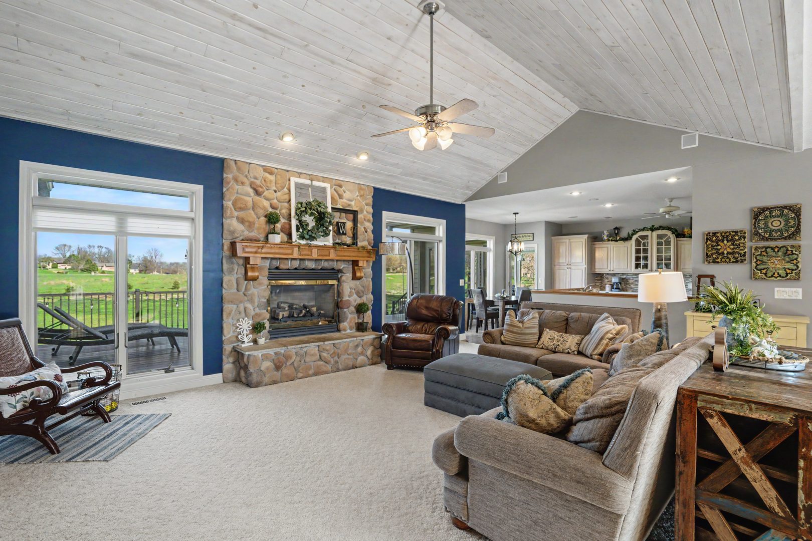918 Melody Hills Fulton, IL 61252 - Photo 9 of 43 a living room with furniture a fireplace and a floor to ceiling window