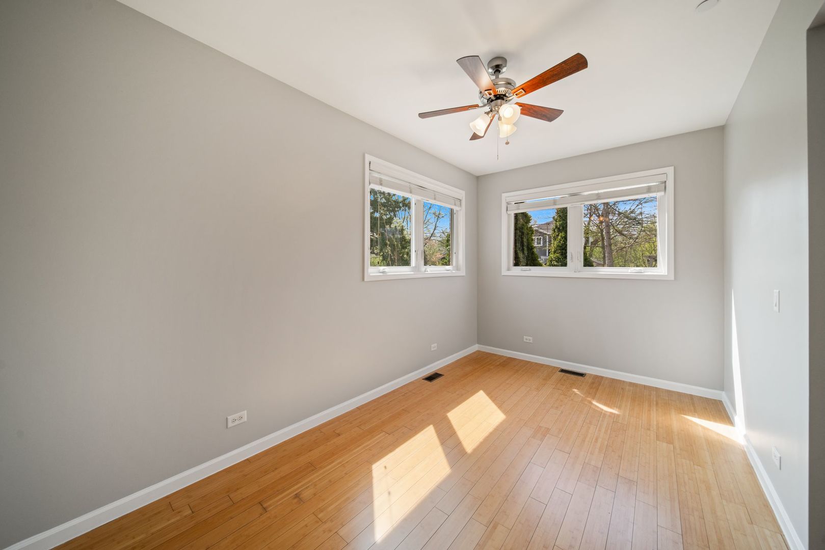 701 Oakton Street Park Ridge, IL 60068 - Photo 16 of 59 a view of an empty room with wooden floor and a window