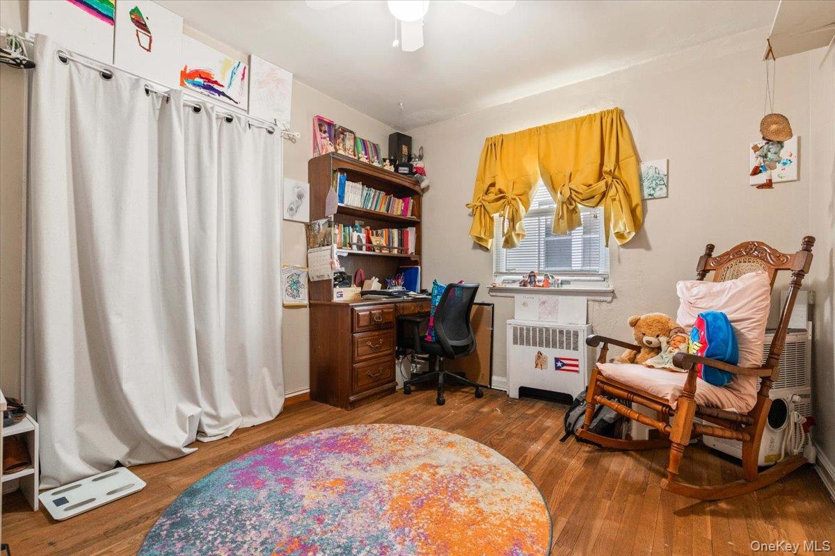 2761 Hering Avenue Bronx, NY 10469 - Photo 16 of 29 Office space with radiator heating unit, dark wood-style flooring, and a ceiling fan
