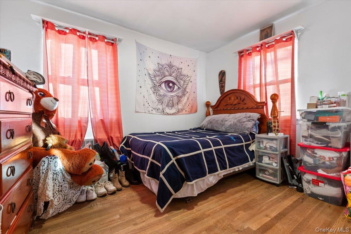 2761 Hering Avenue Bronx, NY 10469 - Photo 17 of 29 Bedroom featuring wood finished floors and multiple windows
