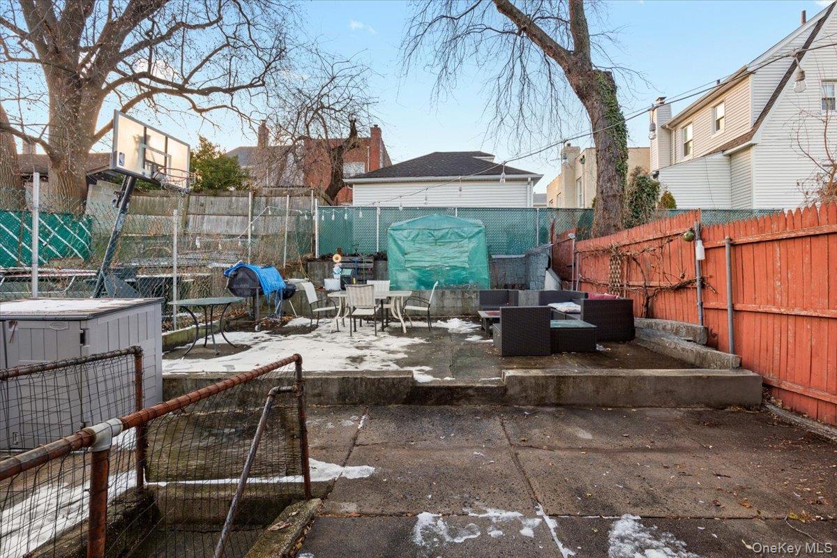 2761 Hering Avenue Bronx, NY 10469 - Photo 21 of 29 Fenced backyard with a patio and an outdoor hangout area