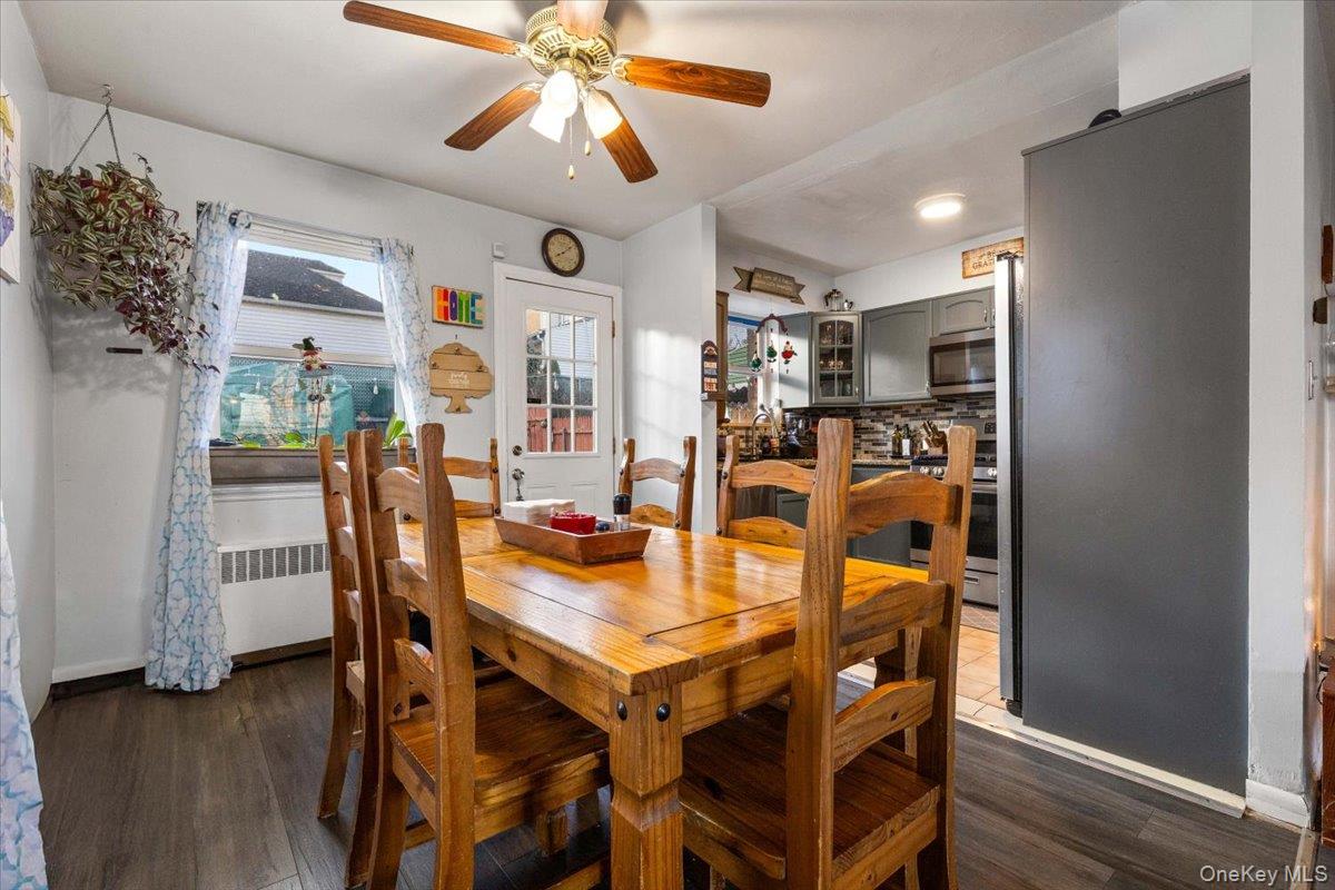 2761 Hering Avenue Bronx, NY 10469 - Photo 10 of 29 Dining space featuring radiator, dark wood-style flooring, and a ceiling fan