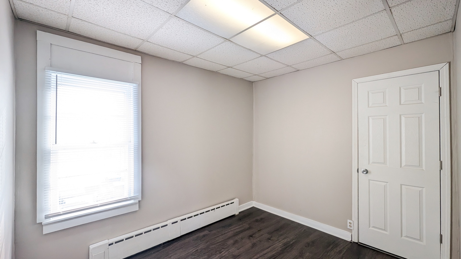 1405 Connor Avenue Lockport, IL 60441 - Photo 8 of 9 a view of an empty room with wooden floor and a window