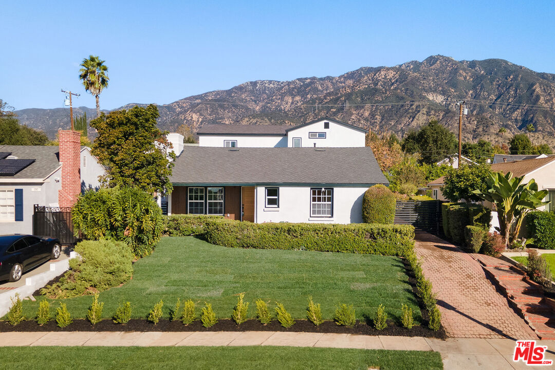 a front view of a house with garden
