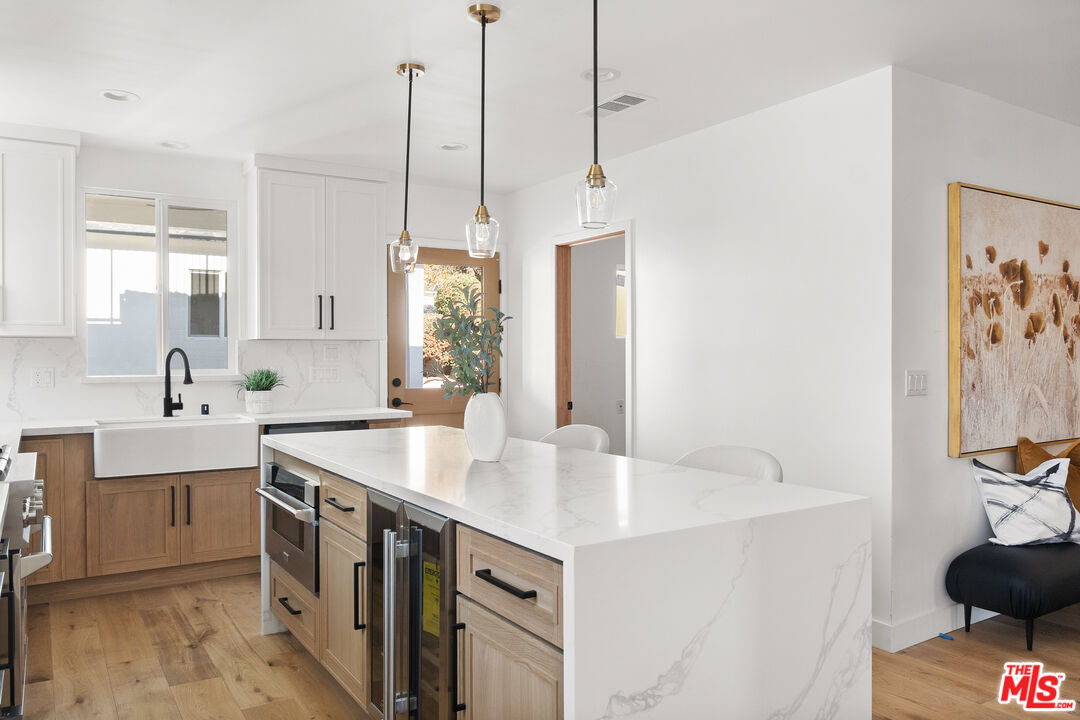 1795 Morada Place Altadena, CA 91001 - Photo 11 of 41 a kitchen with stainless steel appliances a sink a stove and a wooden floor