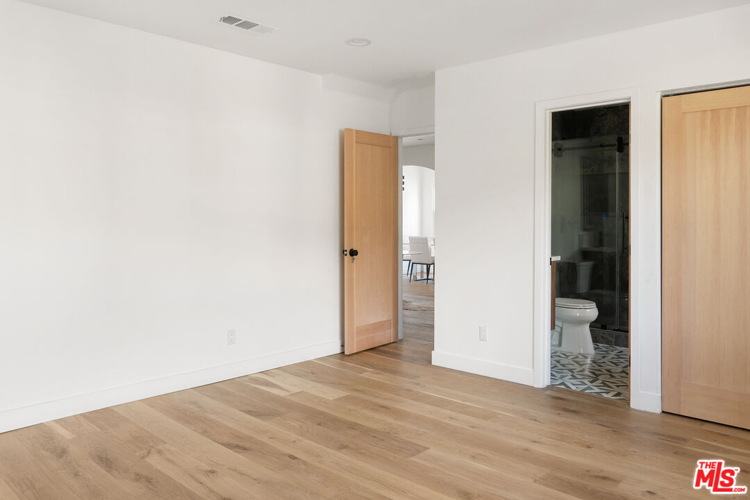 1795 Morada Place Altadena, CA 91001 - Photo 17 of 41 an empty room with wooden floor and bathroom