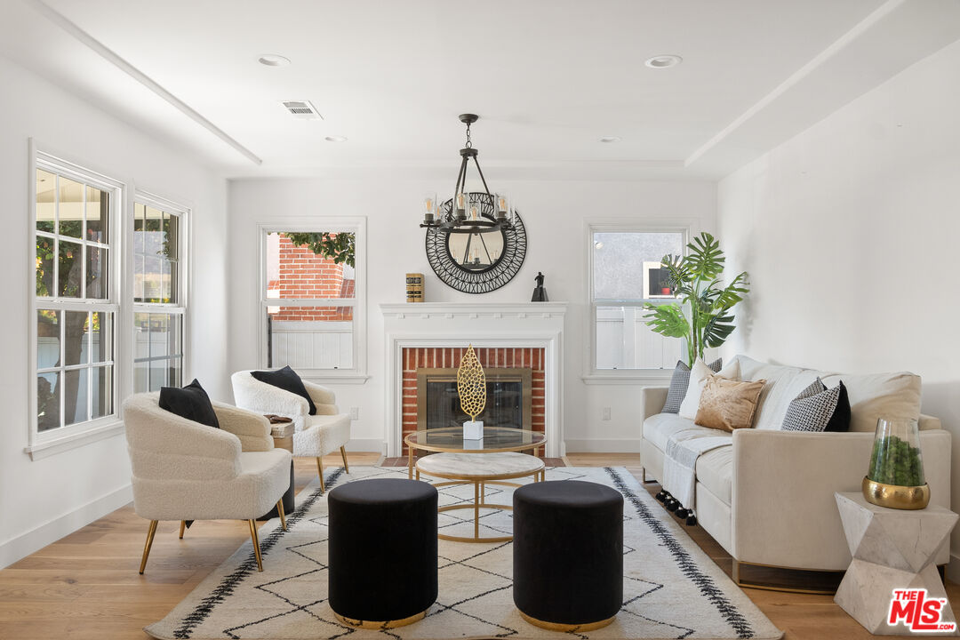 1795 Morada Place Altadena, CA 91001 - Photo 3 of 41 a living room with furniture a fireplace and a potted plant