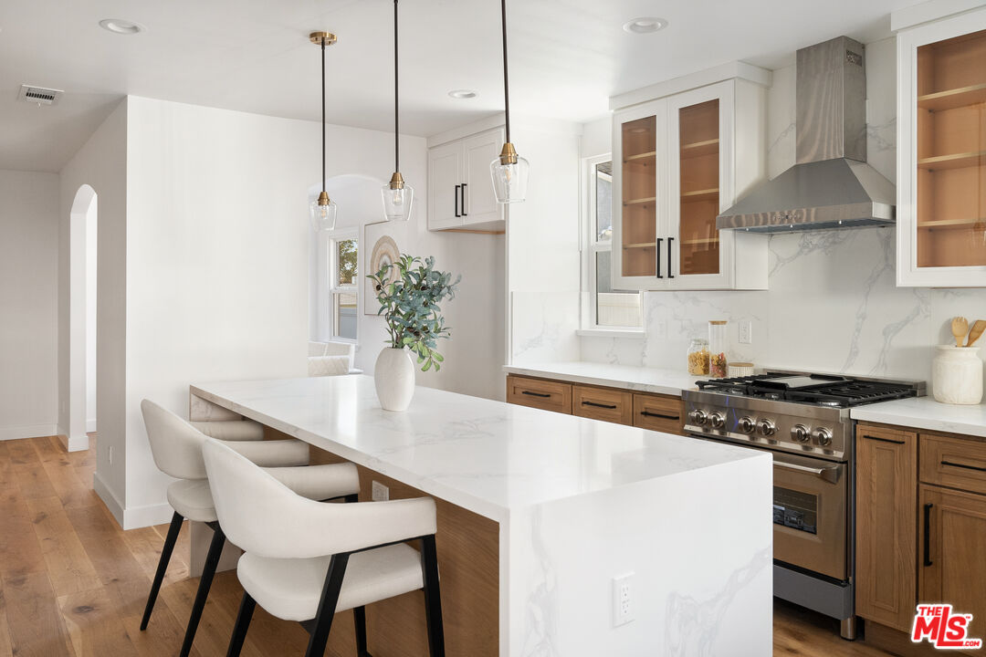 1795 Morada Place Altadena, CA 91001 - Photo 9 of 41 a kitchen with stainless steel appliances kitchen island a table chairs stove and cabinets