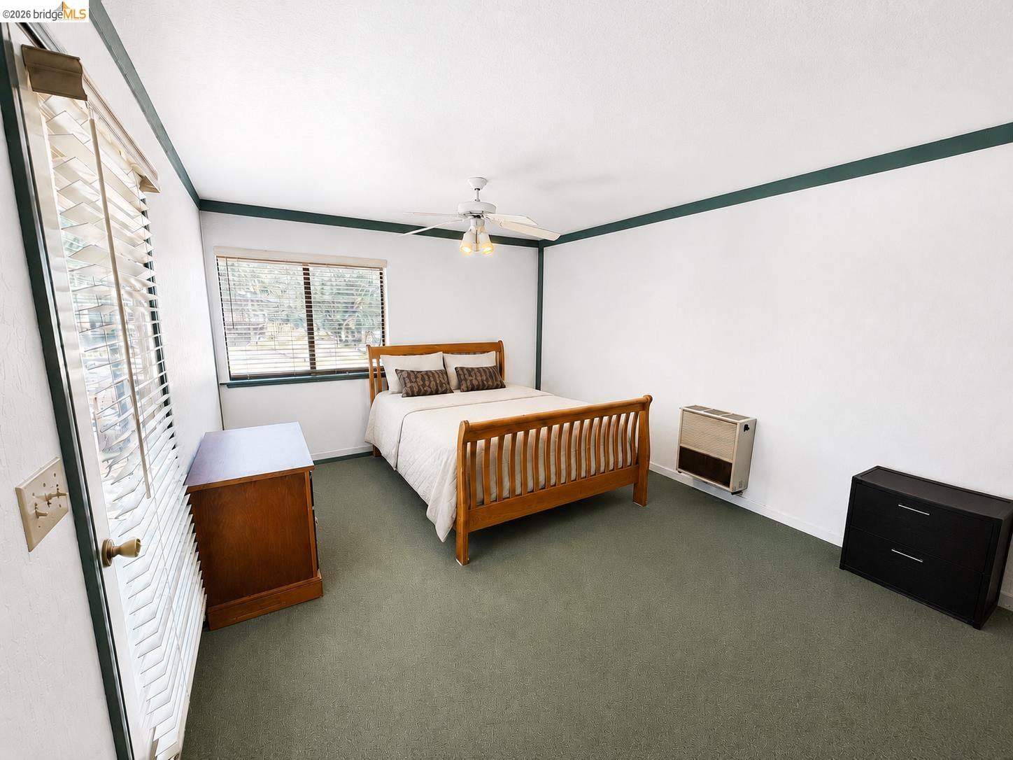 18195 Wards Ferry Road Sonora, CA 95370 - Photo 22 of 67 Carpeted interior space featuring a window with horizontal blinds, a ceiling fan with integrated lighting, and a wall-mounted heating unit