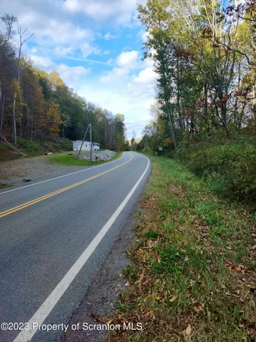 a view of a road with a building in the background