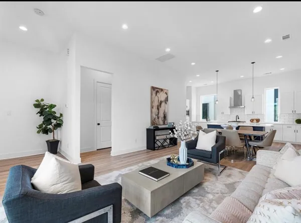 a living room with furniture and a potted plant