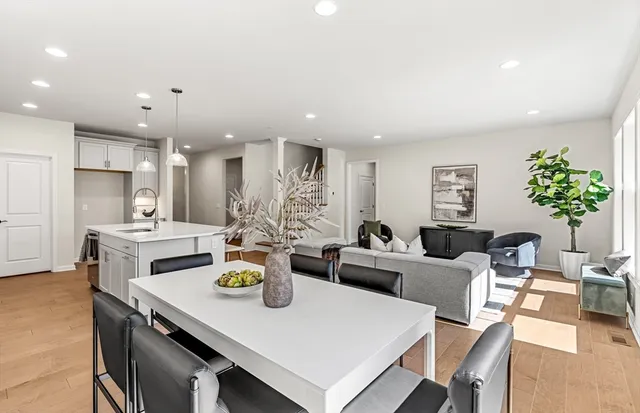 a living room with kitchen island furniture and a potted plant