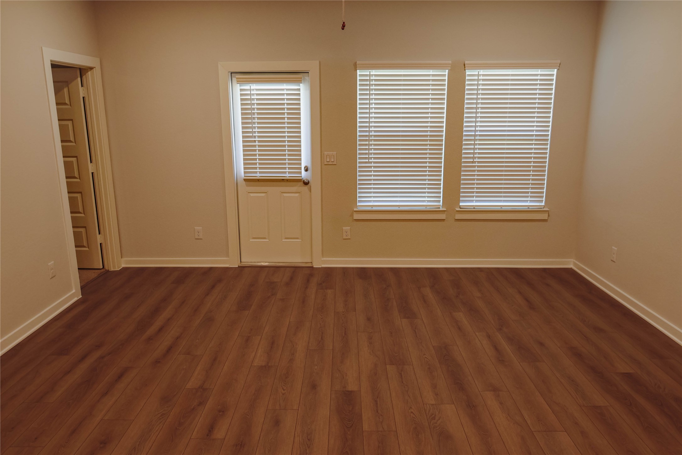 16 Courageous Way Magnolia, TX 77354 - Photo 8 of 19 a view of an empty room with wooden floor and a window