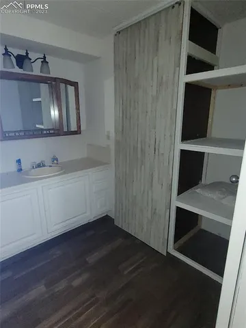 a room with a mirror and cabinets