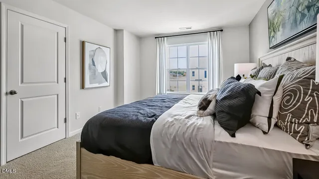 a bedroom with a bed and a painting on the wall