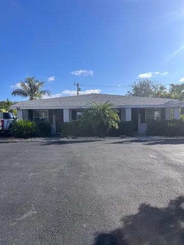 a front view of a house with a yard and a garage