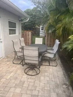 a view of patio with table and chairs and potted plants