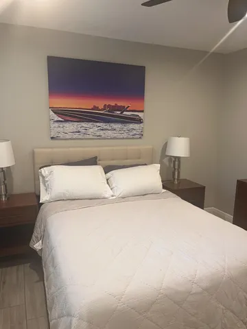 a bedroom with a bed and a night stand