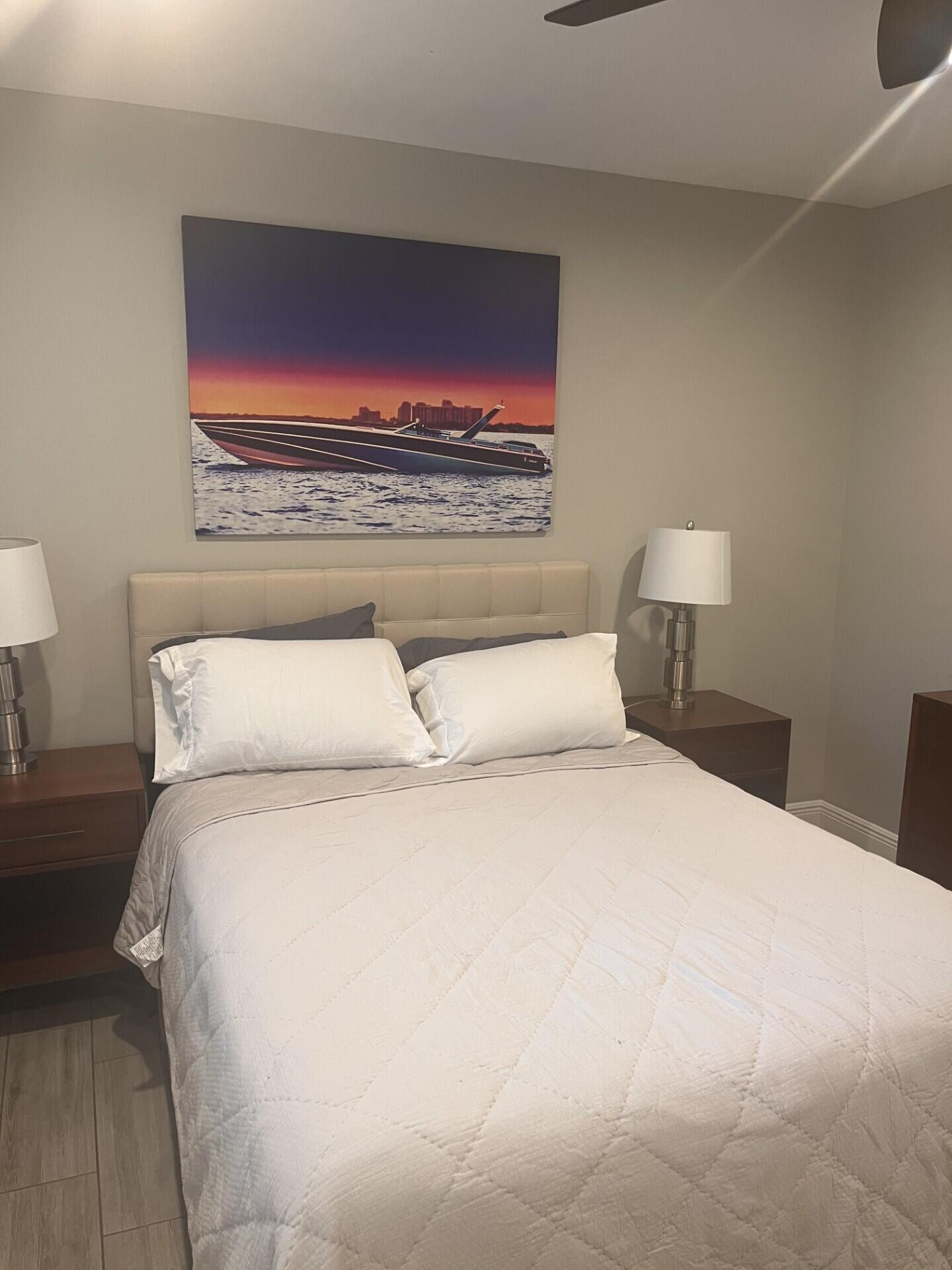 3125 Albatross Road, Unit B Delray Beach, FL 33444 - Photo 9 of 16 a bedroom with a bed and a night stand