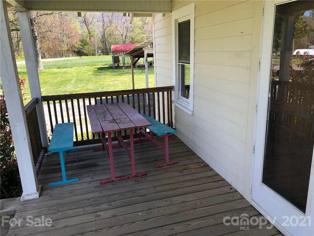 200 Lake Logan Road Canton, NC 28716 - Photo 14 of 41 a view of a balcony with wooden floor and furniture