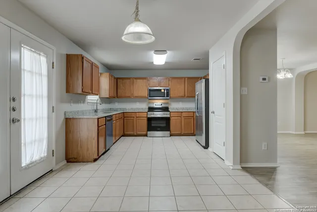 a large kitchen with cabinets and stainless steel appliances